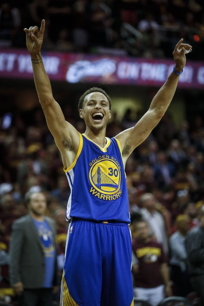 Stephen Curry with arms raised.