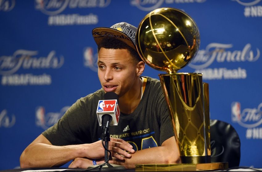 Stephen Curry with NBA Finals trophy