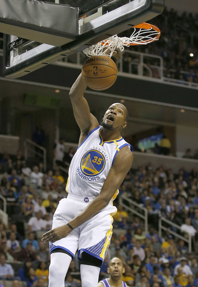 Golden State Warriors' Kevin Durant (35) dunks against the Sacramento Kings during the first half of a preseason NBA basketball game Thursday, Oct. 6, 2016, in San Jose, Calif. (AP Photo/Tony Avelar)