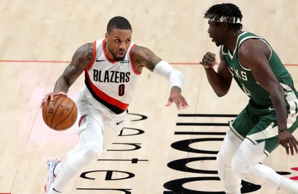 Damian Lillard drives against Jrue Holiday in a game last season.