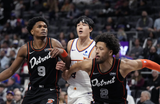 Phoenix Suns forward Yuta Watanabe, center, waits on the rebound with Detroit Pistons forward Ausar Thompson (9) and guard Cade Cunningham (2) during the first half of an NBA basketball game, Sunday, Nov. 5, 2023, in Detroit. (AP Photo/Carlos Osorio)
